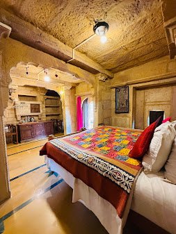 Stone vaulted room with colourful bedspread